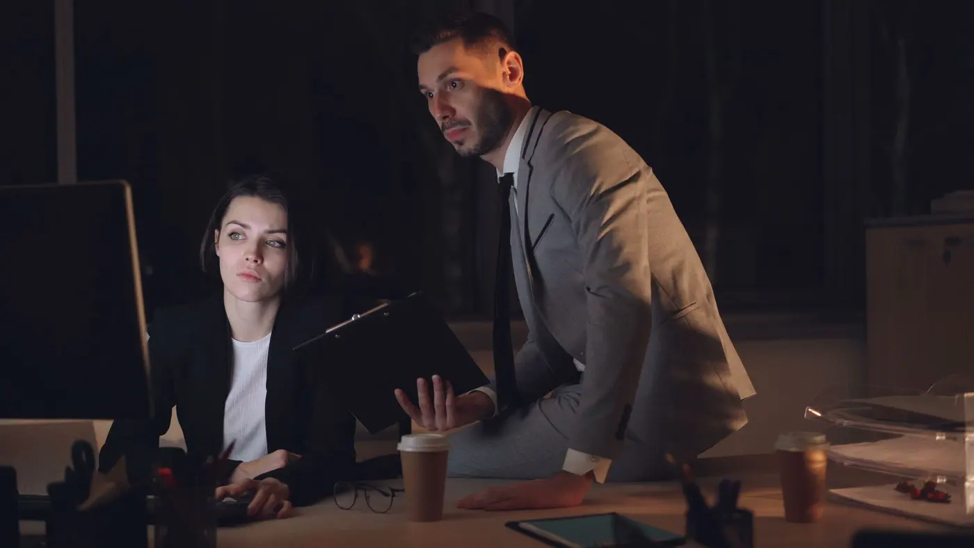 Strategists and designers discussing a project late in the office